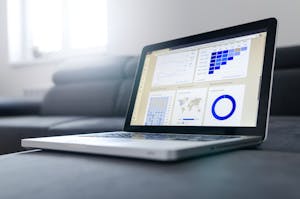 Sleek laptop showcasing data analytics and graphs on the screen in a bright room.